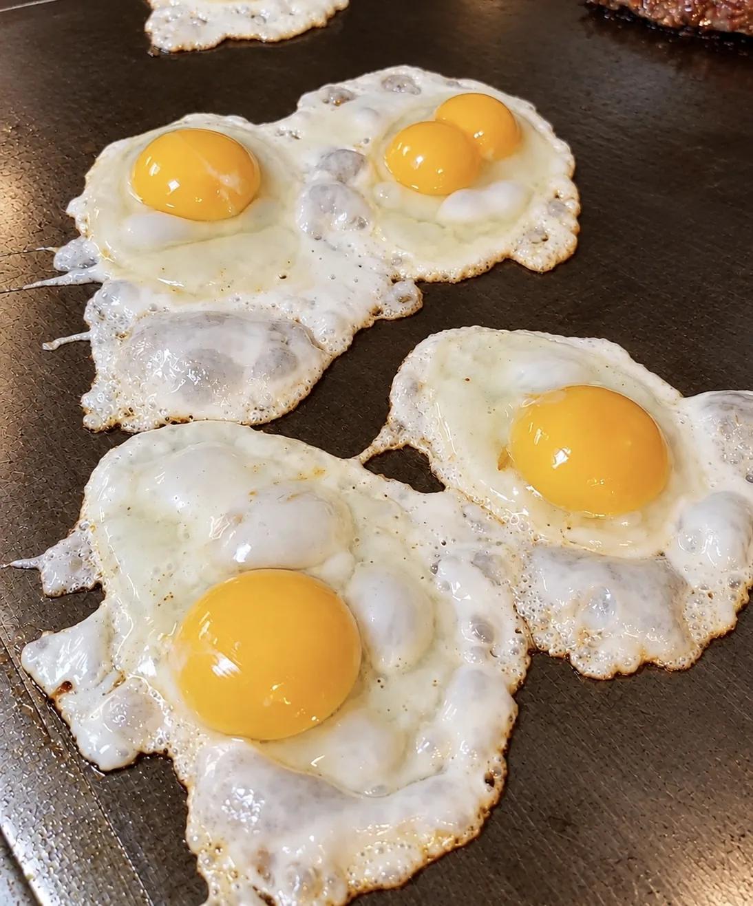 Sunny side up eggs on the griddle